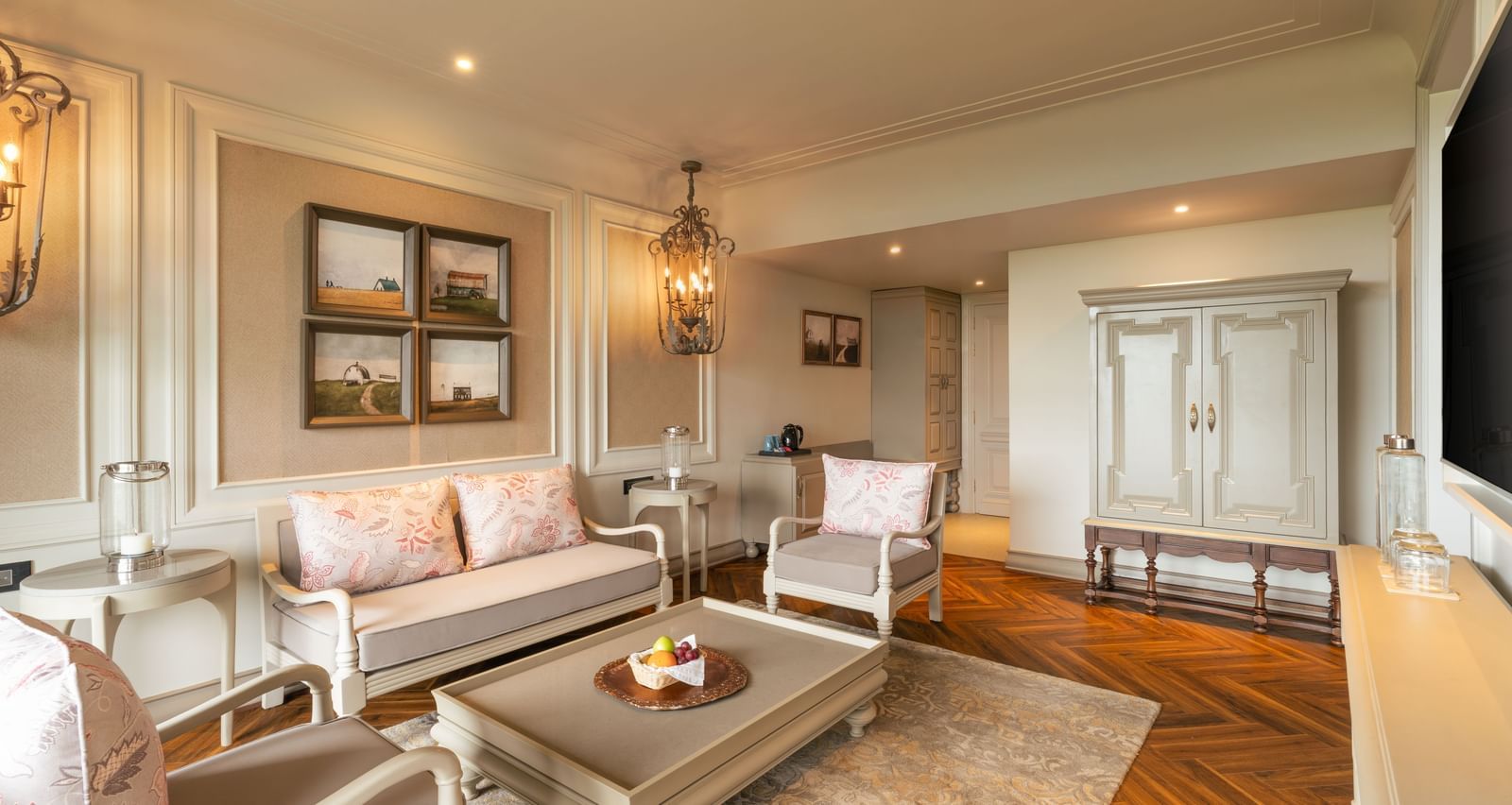 A wide-angle shot of the spacious living room at the Evren Suite featuring a beautiful couch set along with a coffee table in front of it at The Evren, Vagator.