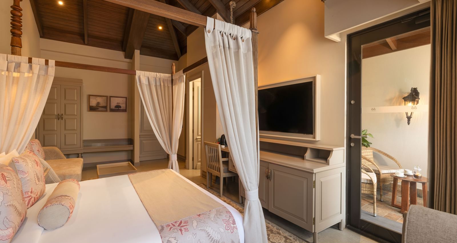 Side view of the Executive Room featuring a double bed with a television unit in front of it at The Evren, Vagator.