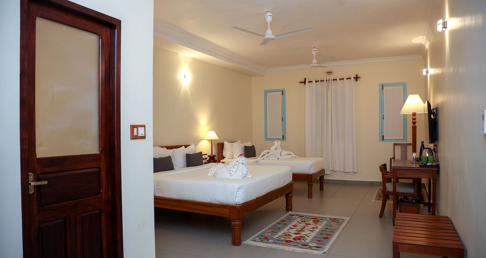 A master suite bedroom with two beds, tables and other furnitures  | Mango Hill La Serene, Pondicherry