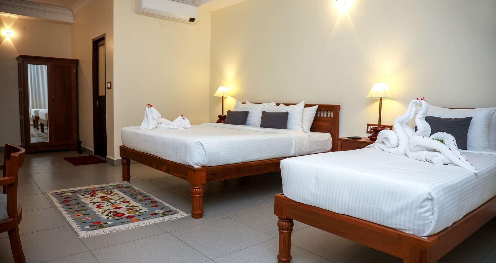 A large bedroom with two beds placed beside each other | Mango Hill La Serene, Pondicherry
