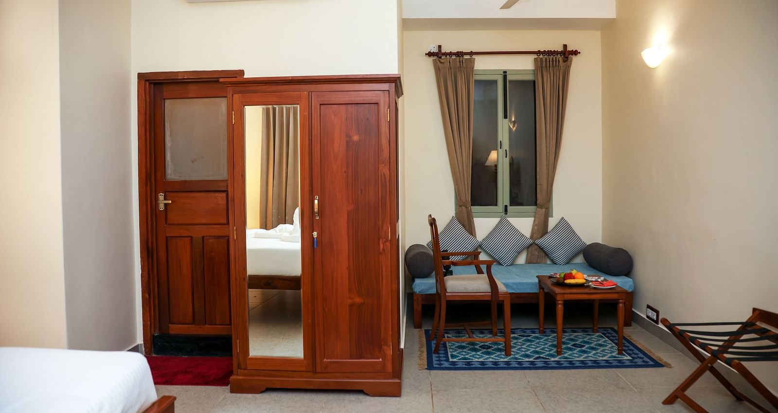 A sitting area, a cupboard, and a tall lamp | Mango Hill La Serene, Pondicherry