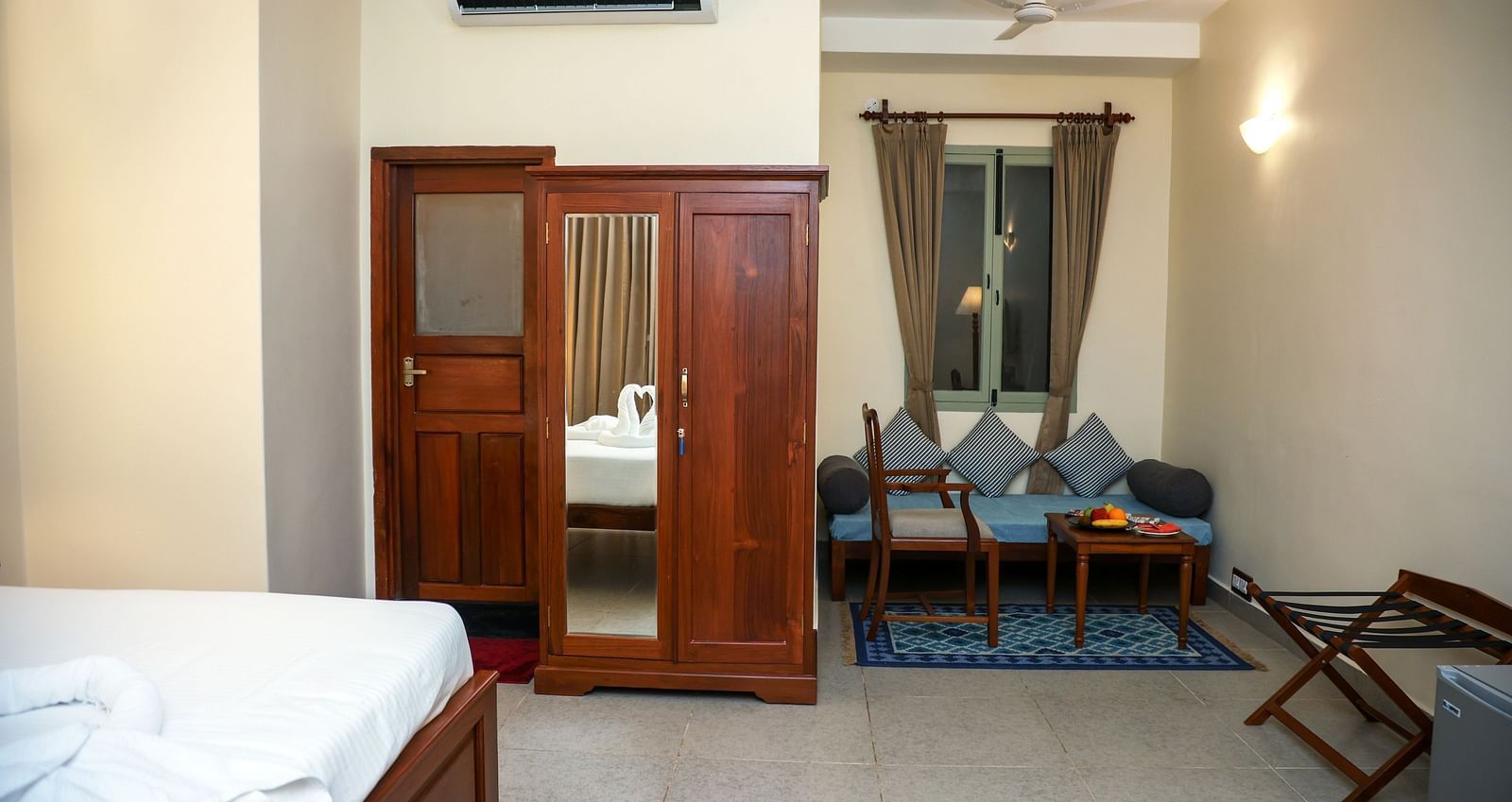 A sitting area, a cupboard, and a tall lamp | Mango Hill La Serene, Pondicherry