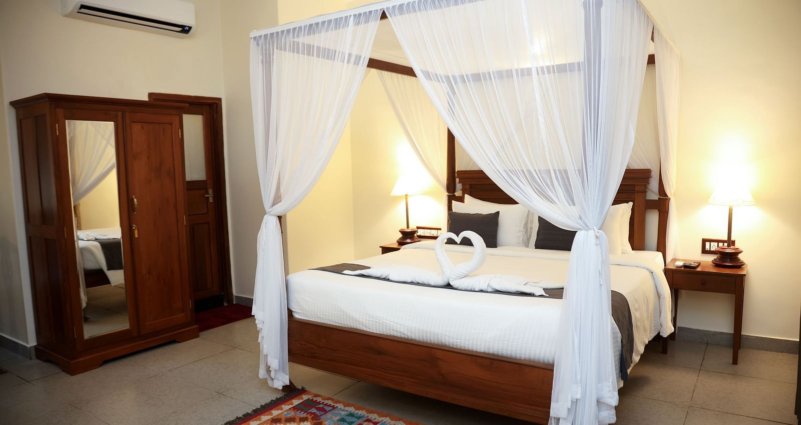 A four-posted bed decorated with pieces of cloth on each angles | Mango Hill La Serene, Pondicherry