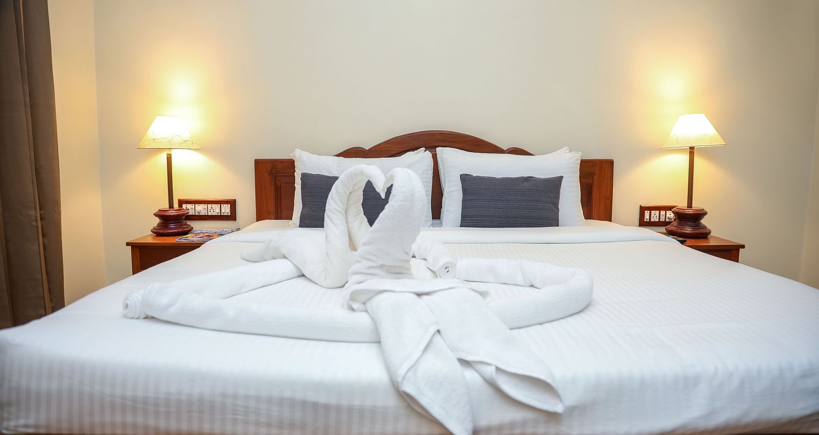 A large sized bed that is decorated with swans made out of towels | Mango Hill La Serene, Pondicherry