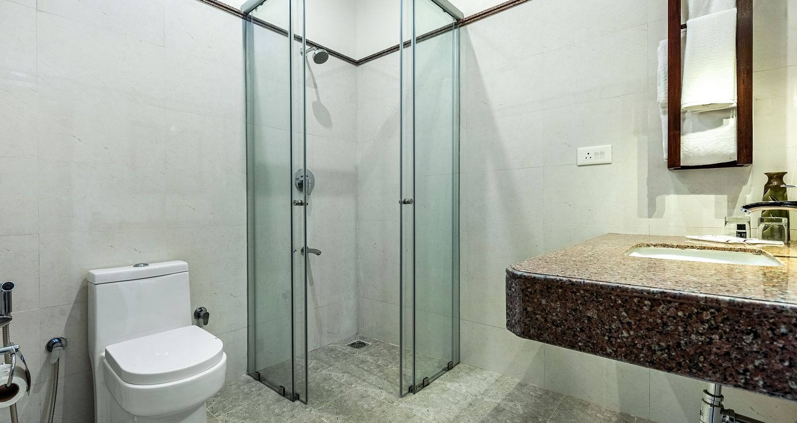 Bathroom with a glass shower and granite countertop | Mango Hill Shallow Beach Resort ECR