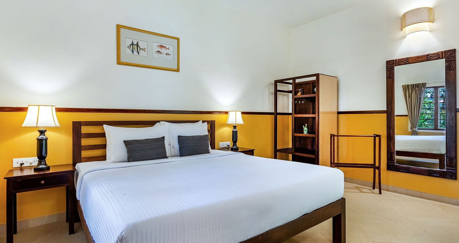  Bedroom with a double bed, nightstands, lamps, a mirror, and a shelving unit | Mango Hill Shallow Beach Resort ECR