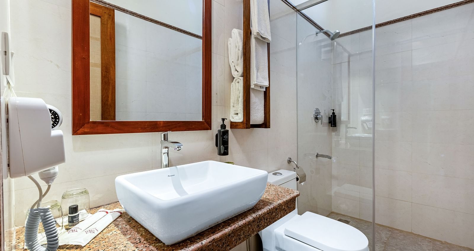 Bathroom with a sink, mirror, toilet, and glass shower enclosure | Mango Hill Shallow Beach Resort ECR
