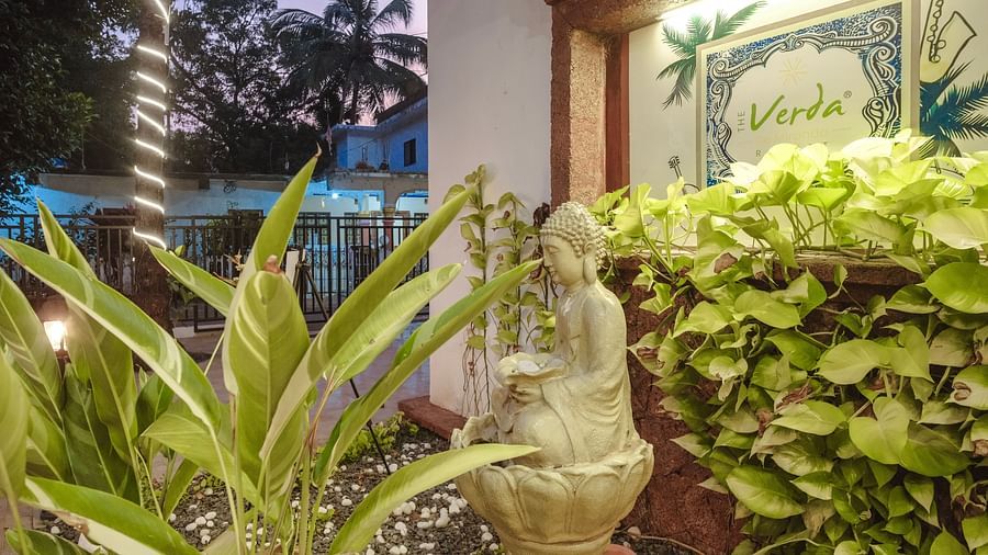 Close-up of a Buddha fountain amidst tropical greenery at The Verda de Miranda Resort.