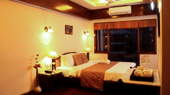 a bed with a window beside it  5 - Polo Towers, Shillong