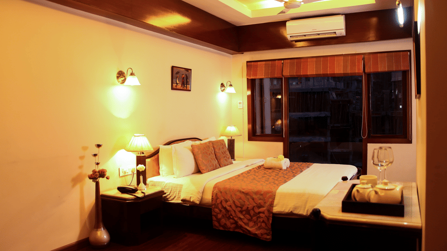 a bed with a window beside it  5 - Polo Towers, Shillong