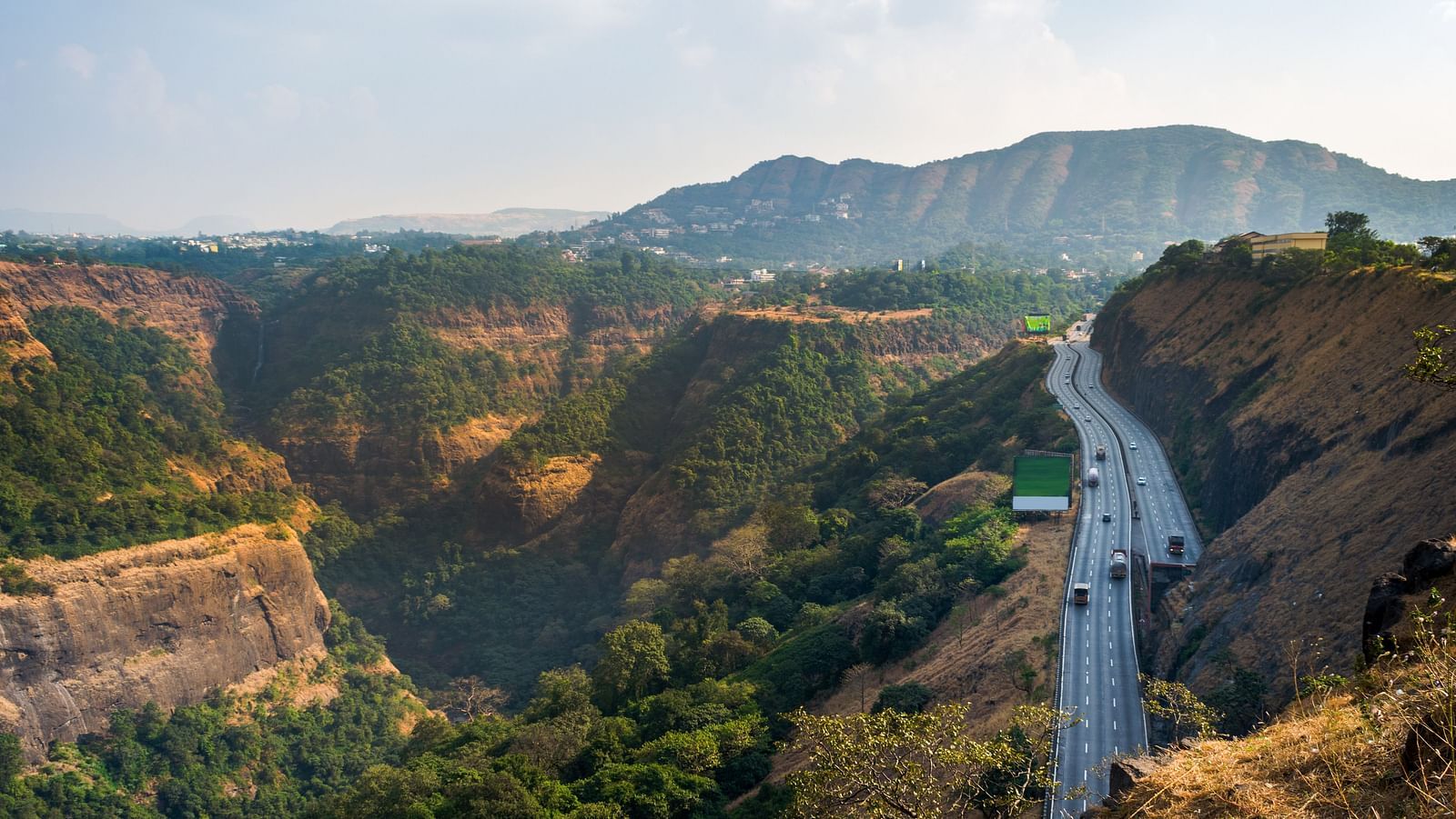 A view of Khandala hill station from afar with a highway on the right hands side