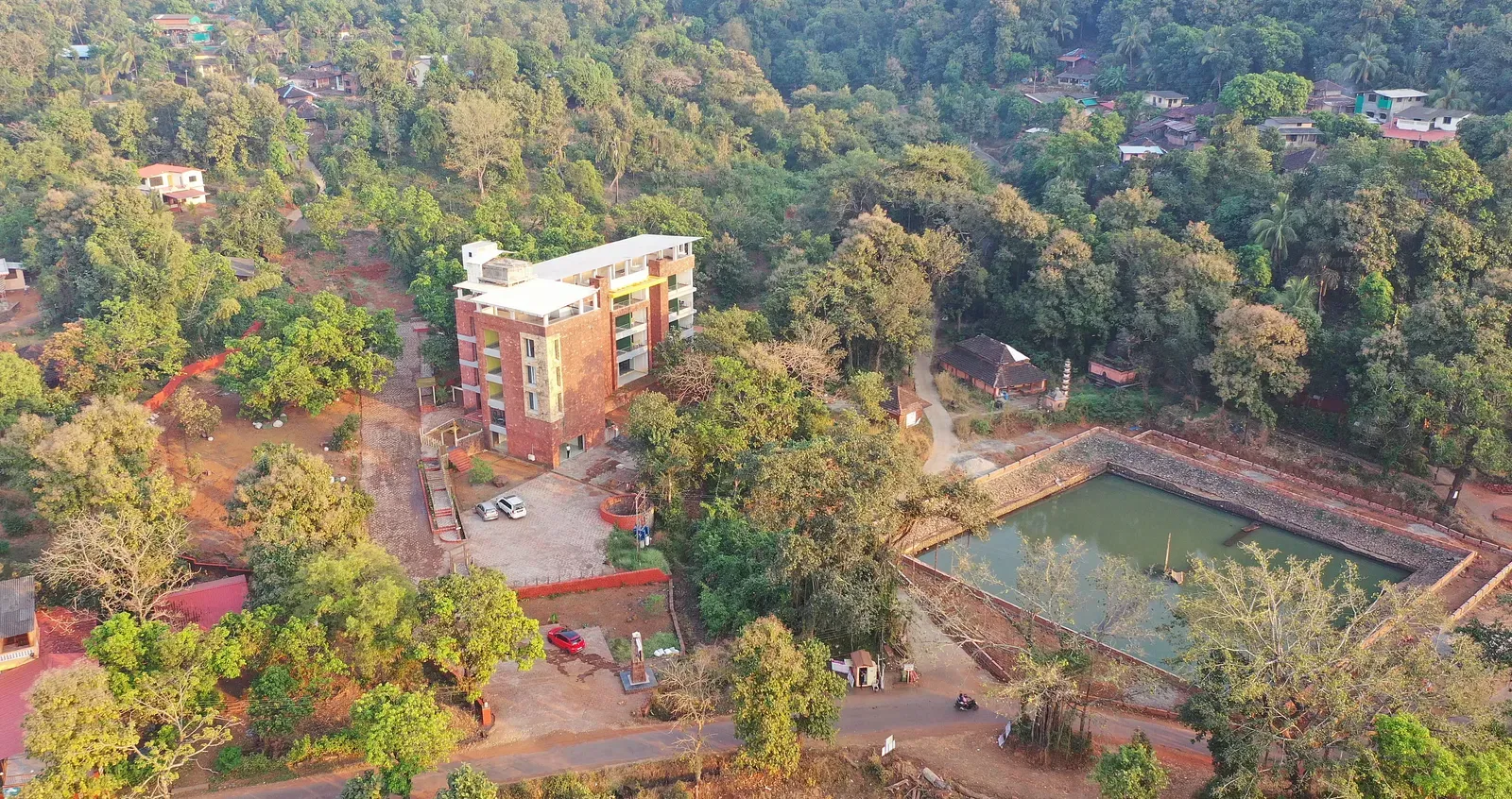 An overview of SeaFort Beach Resort surrounded by lush greenery and a water body nearby.