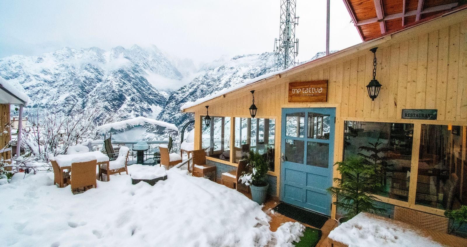 image of the tattva, joshimath featuring the outdoor dining area with a think blanket of white snow