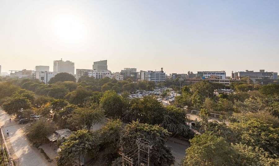 Panoramic skyline view with trees and buildings under a clear sky from Hotel Bawa, Gurgaon.