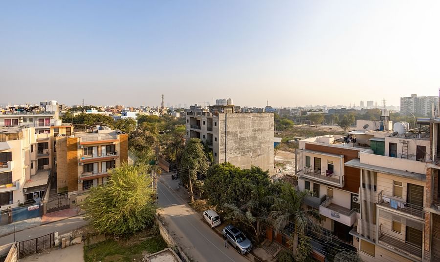 Urban neighbourhood view with residential buildings and greenery from Hotel Bawa, Gurgaon.