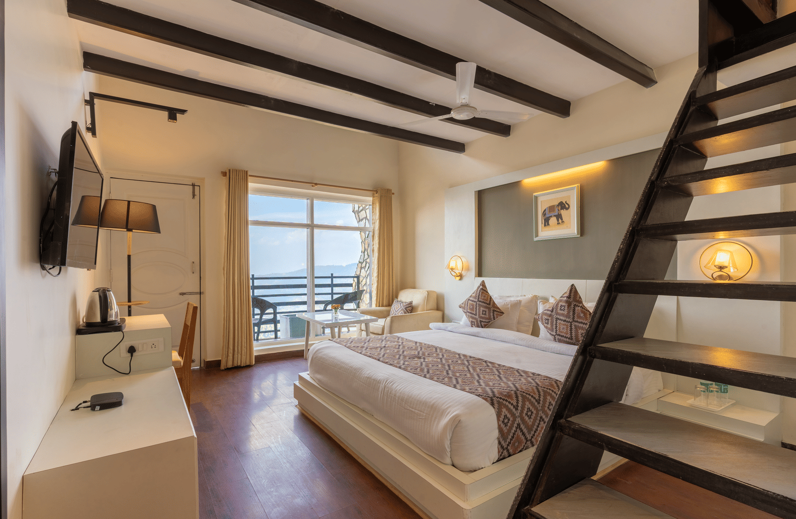 A modern guest suite featuring a white bed and a wooden staircase leading to a mezzanine level at Himalayas Resort By The Lake Hill, Mukteshwar.