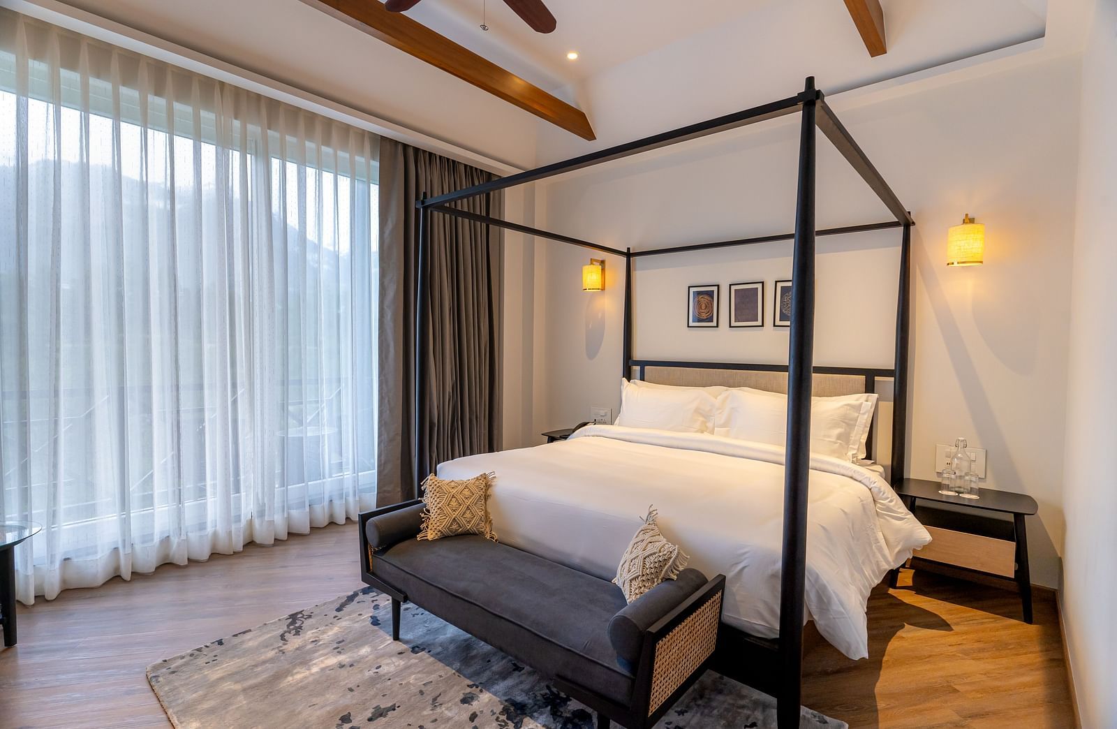 Bedroom with a four-poster bed, bench, and rug at Nivasana Manali.