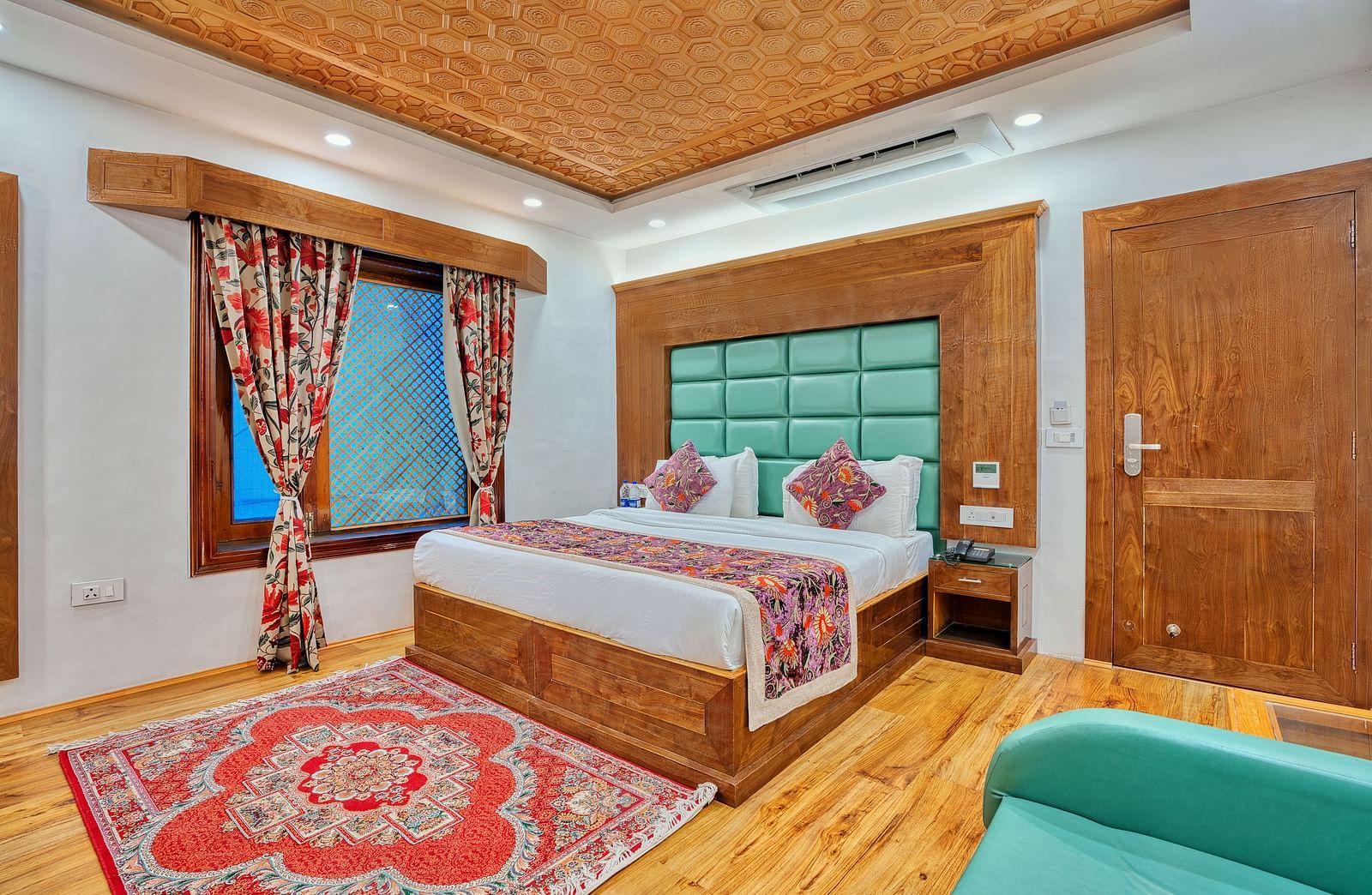 Cosy guest room with traditional decor and modern comfort at Royal Comfort Regency, designed for a peaceful and elegant stay.