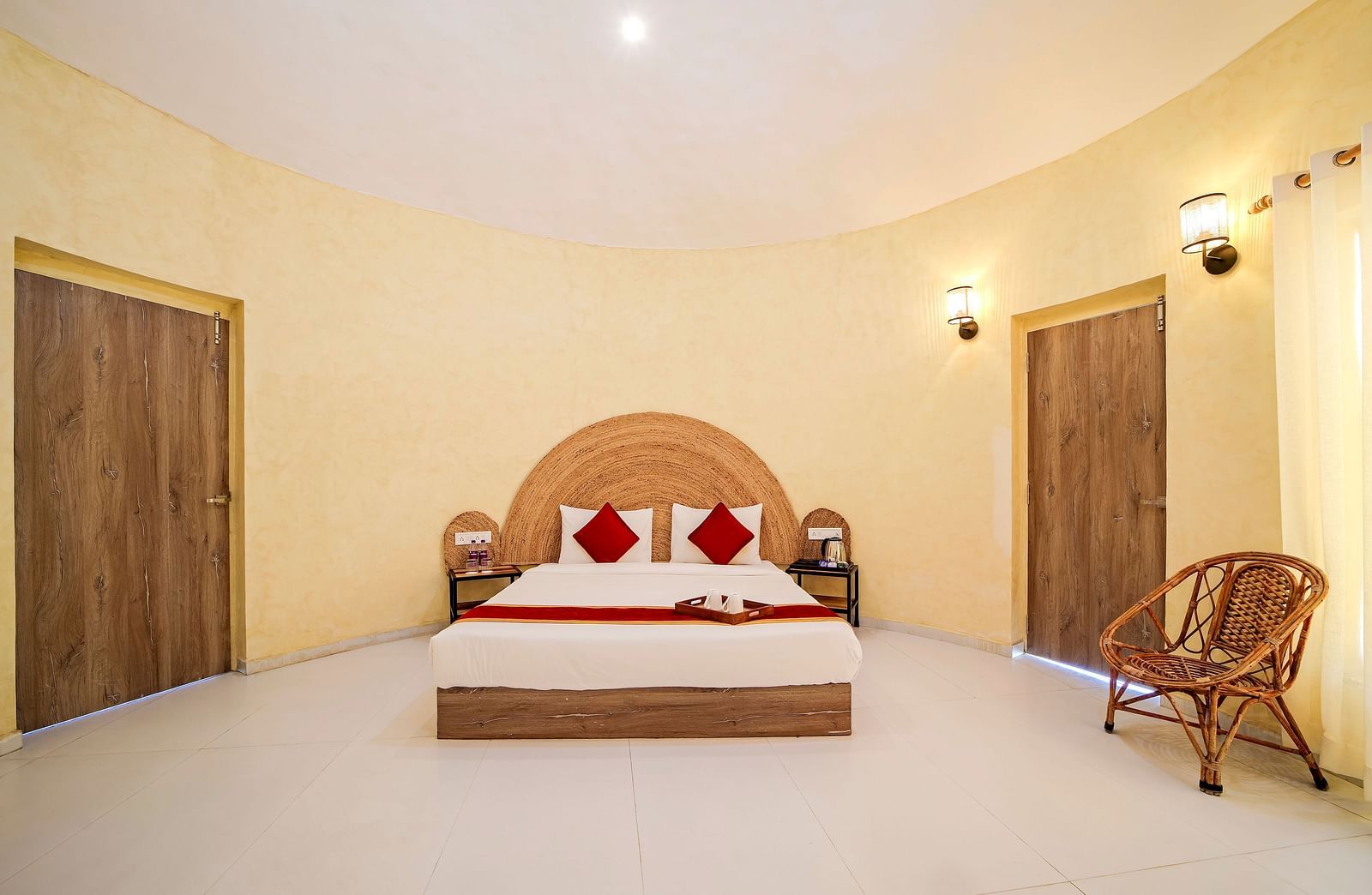 Front view of a room with a bed and a rattan chair on the side at Valley by Grassfield.