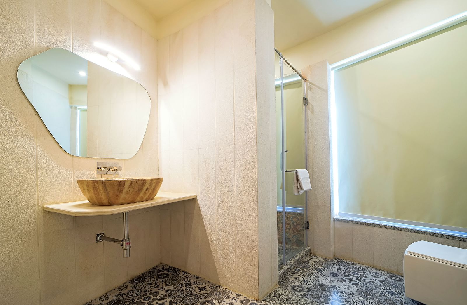 A washroom at Valley by Grassfield featuring a sink, a mirror, and a light above it.