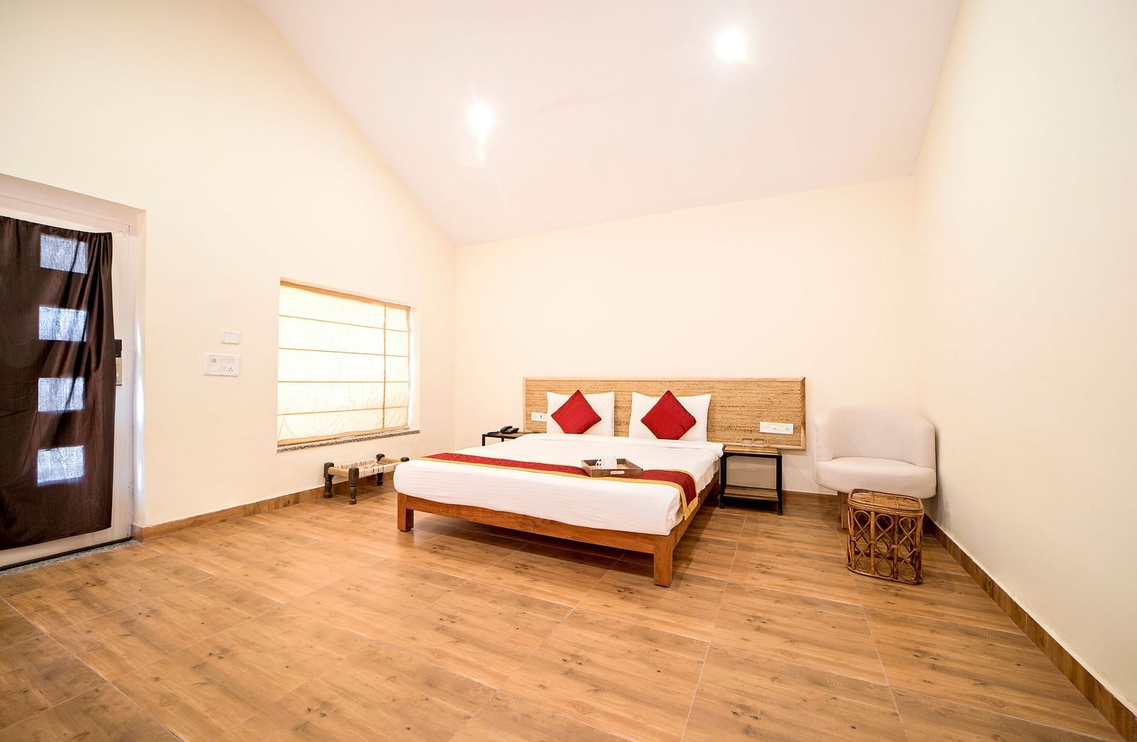 A room at Valley by Grassfield featuring a bed, a window on the side, and ceiling lights.