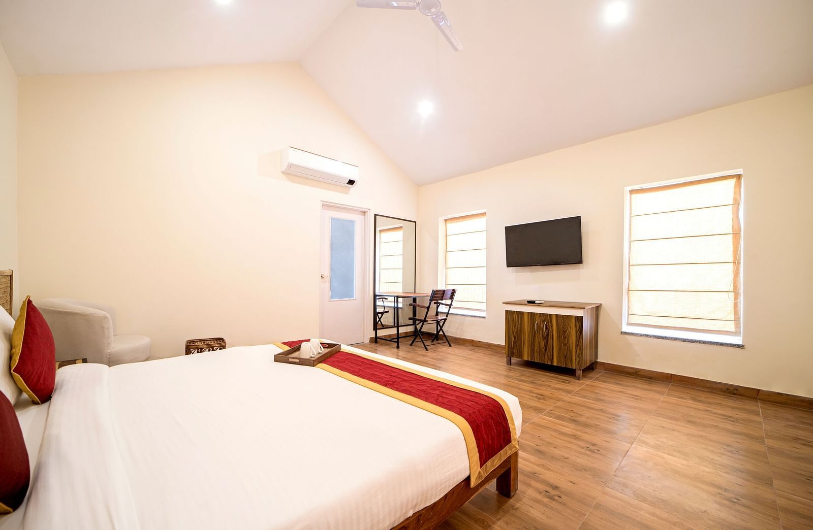 Side view of a room with a bed and a television and a window in front at Valley by Grassfield.