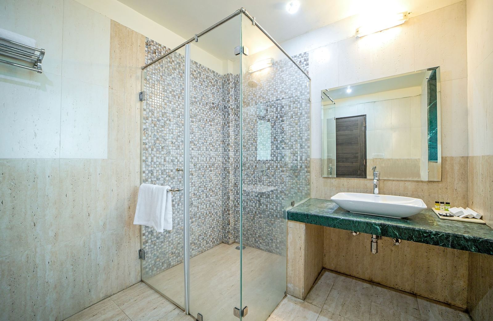 A washroom at Valley by Grassfield featuring a glass shower cubicle and a sink on the side.