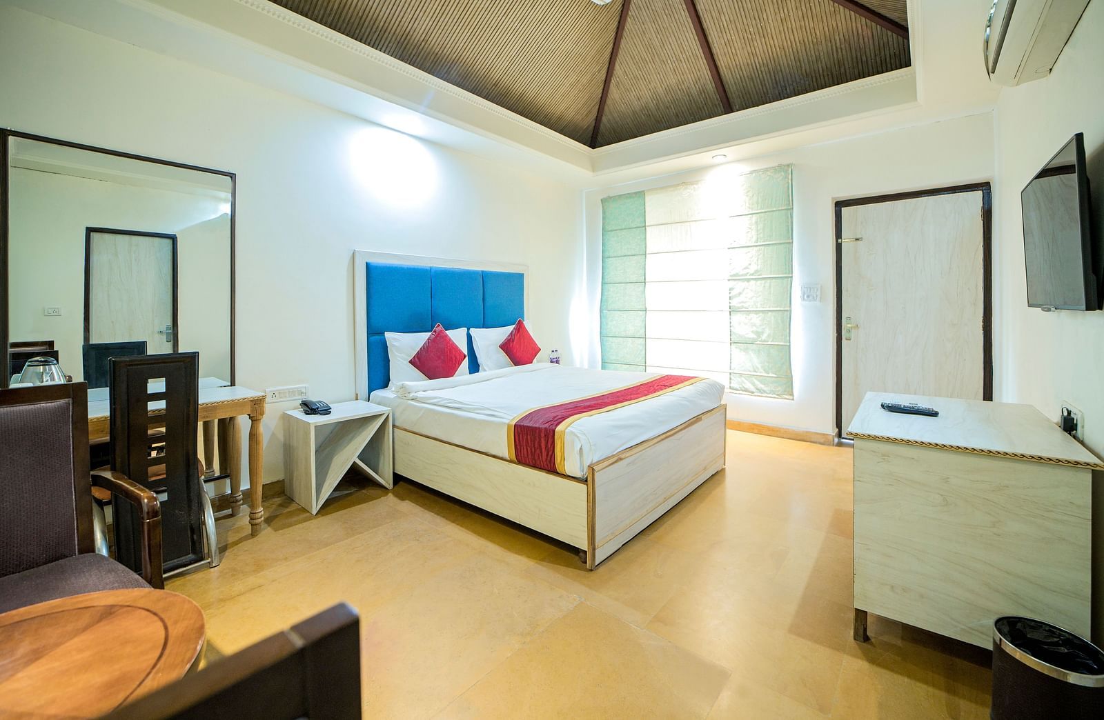 Side view of a room featuring a bed, a window on one side, and a sofa on the other at Valley by Grassfield.