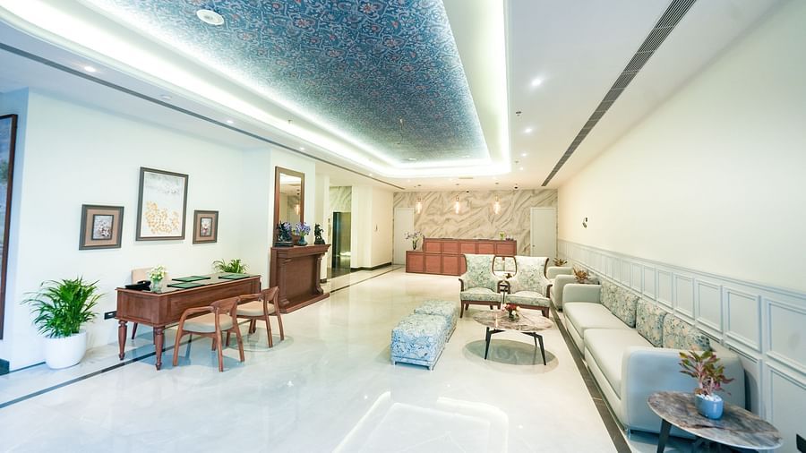 A picture of a lobby featuring a comfortable sofa, a wooden reception desk, stylish furniture, and potted plants that enrich the atmosphere - NAMAMI BY ZENQ BANKHANDI
