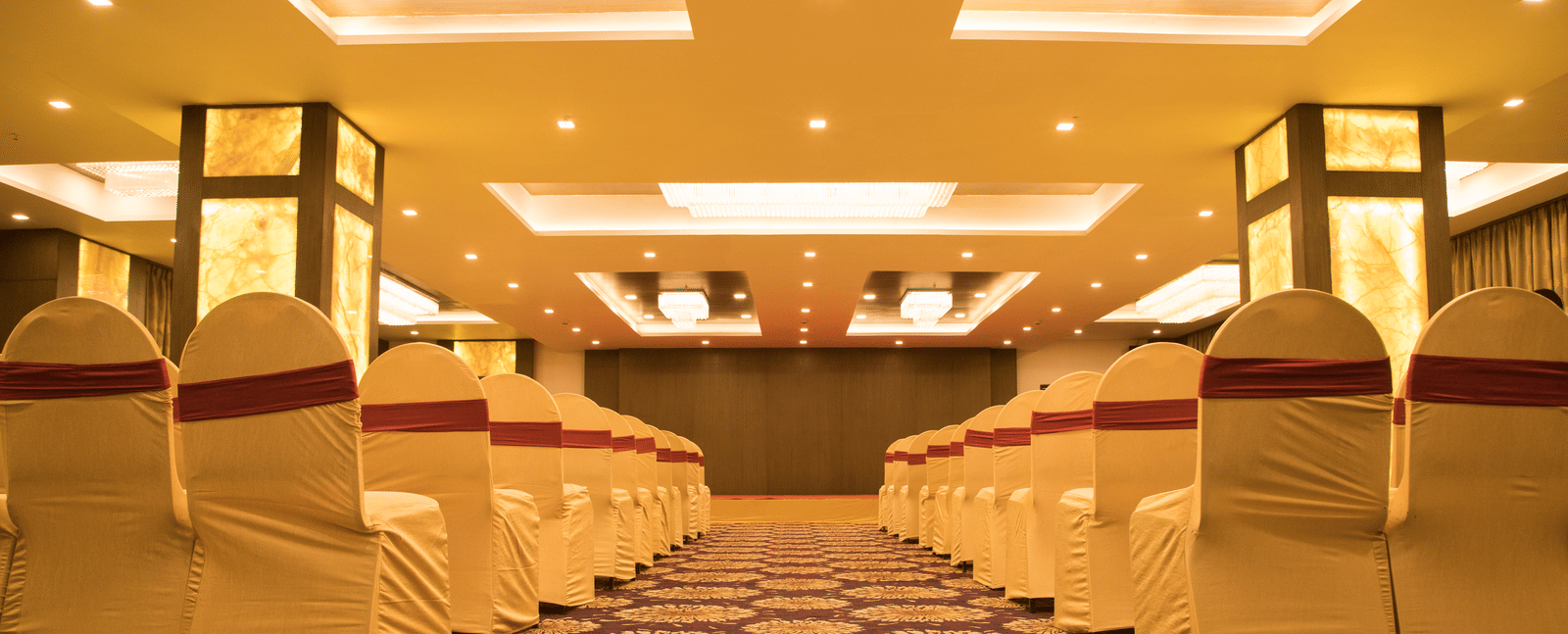 A conference or event room at Benzz Park Chennai with rows of chairs facing a central aisle.