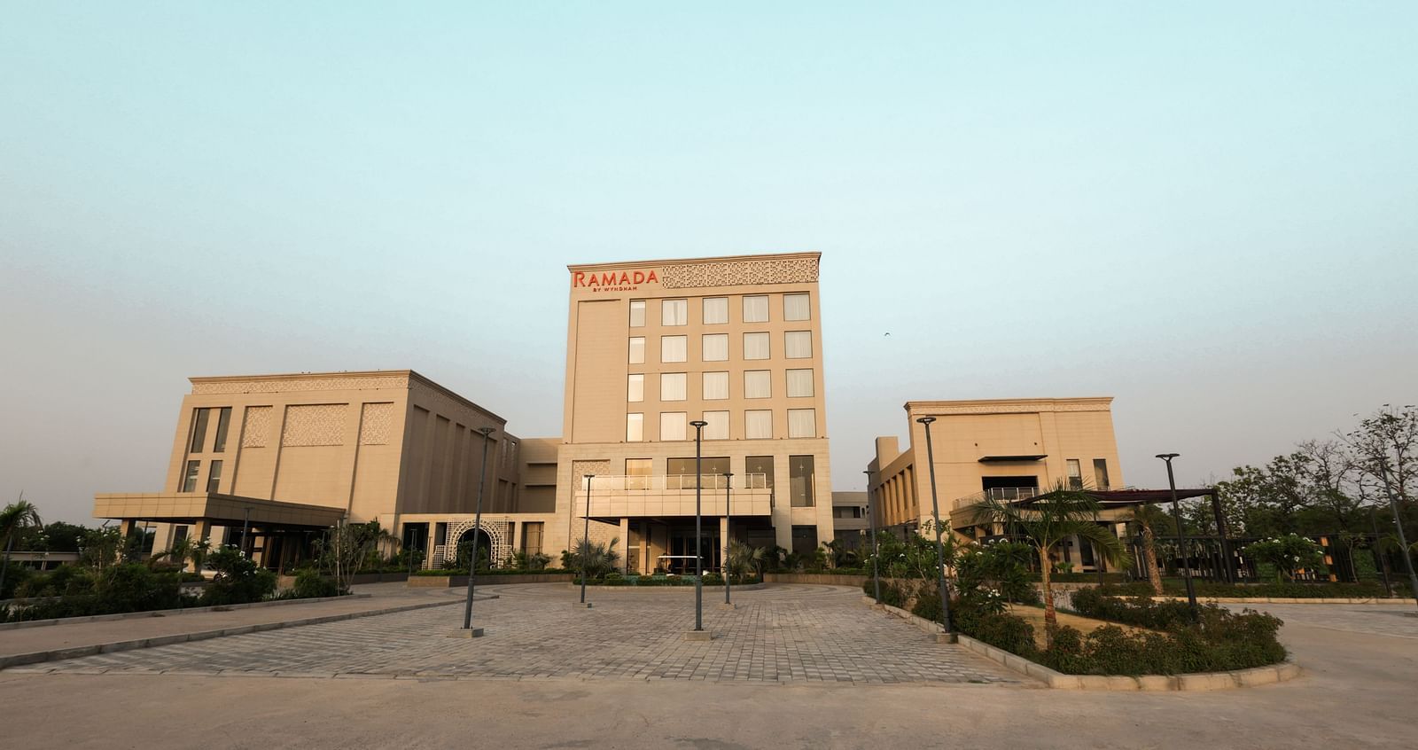 Wide-angle view of Ramada by Wyndham Sonipat Murthal exterior and landscaped entry