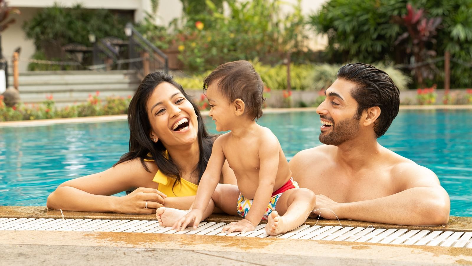 an image of a Parent and kid enjoying the swimming pool