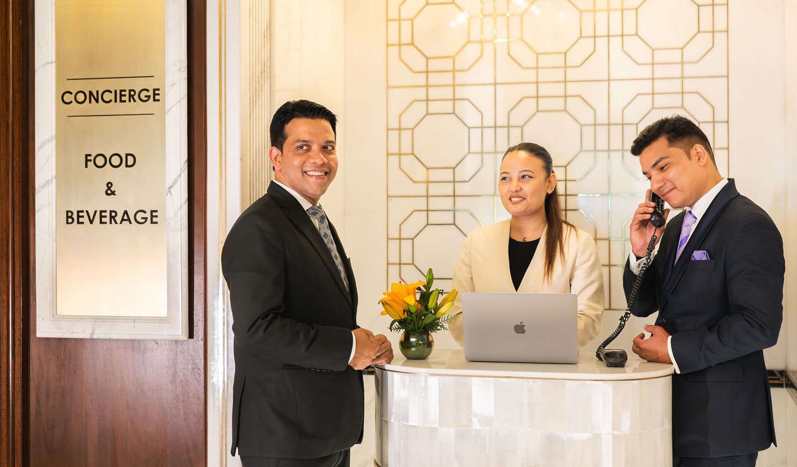 image of people dressed in business formals at logo of the Cinqtuair spa at The Claridges New Delhi