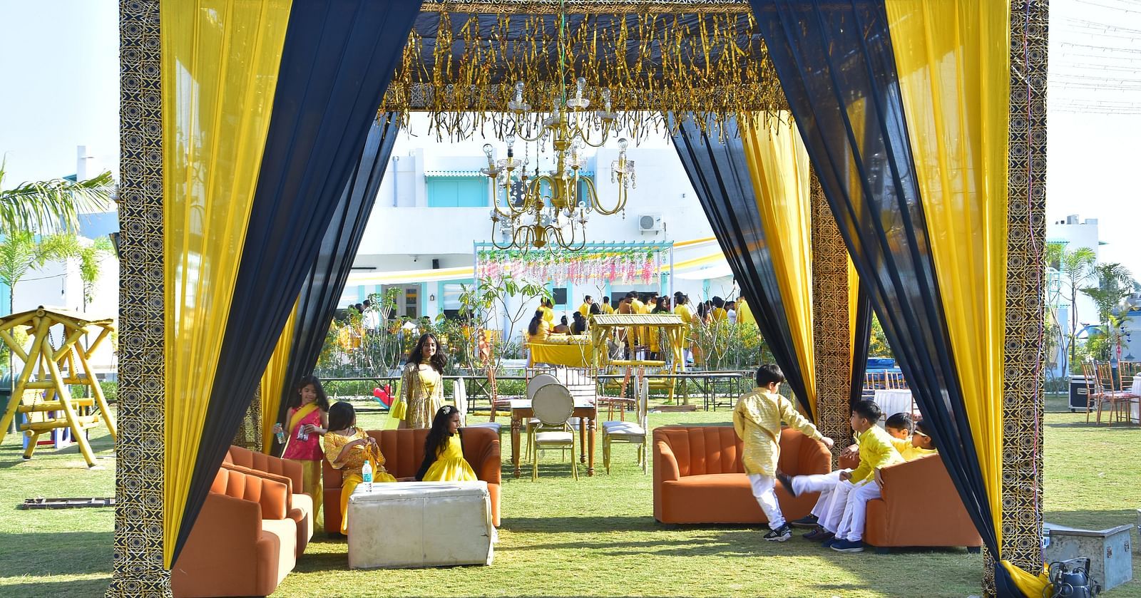Outdoor seating lounge setup for sangeet night at Vedikant Resorts The Mallard Corbett with clear blue sky in the background.
