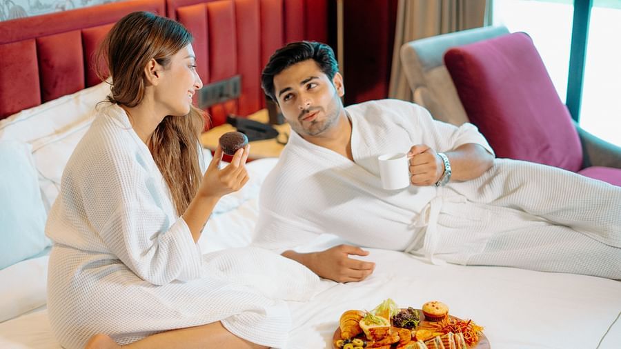 A couple enjoying in-room dining, savouring each others company through conversation at Crescent Spa & Resort, Indore