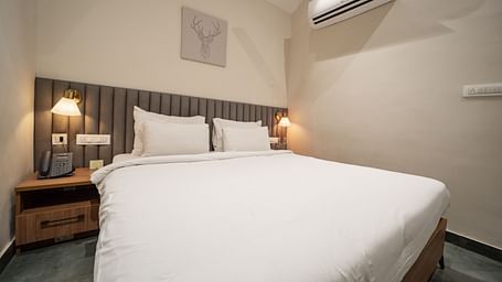 An image of a room with king size bed, bed side tables, lamps - Trance Veechika Resort, Vikarabad