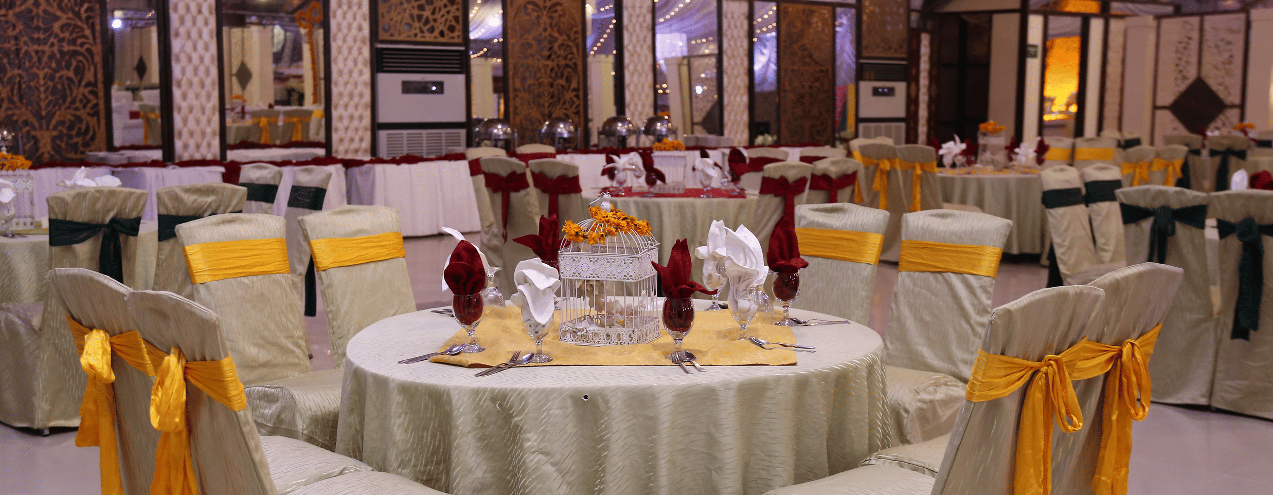 banquet hall with tables and chairs arranged with decoration