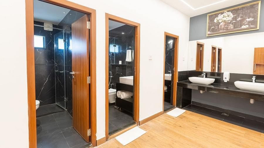 image of the washroom area with three separate fully equipped bathrooms at the luxury group stay villa - Darza Resorts