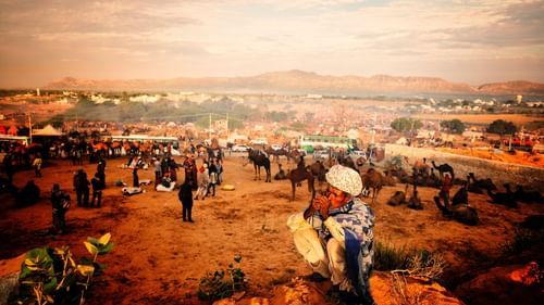 person sitting on a rock while smoking