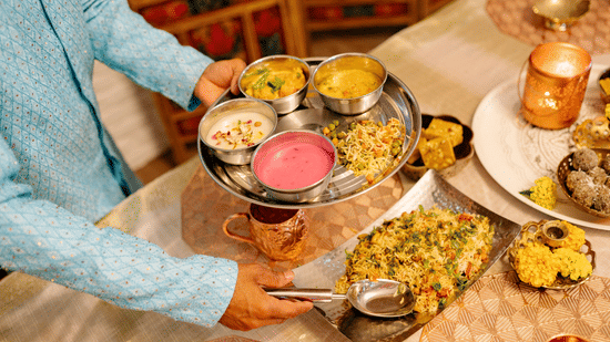 A traditional Indian thali being served with multiple dishes and accompaniments at Bhavanis Vista By Icon Hosur.