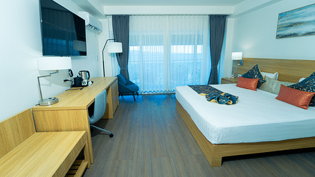 An image of a hotel room in Montego Bay with a king size bed and a wall mounted television - Hotel 39, Jamaica (Montego Bay)