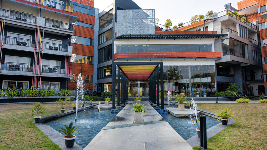 Front entrance of Hotel Sonar Bangla, Taki, with fountains and landscaping.