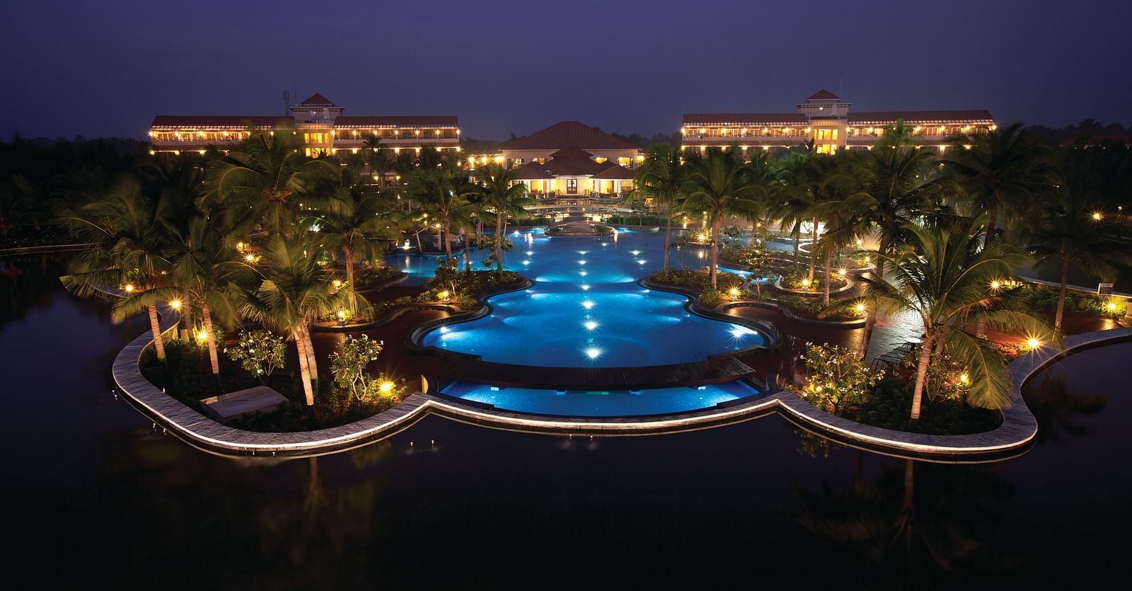 Wide angle Night View of the swimming pool and facade at Ocean Spray, Pondicherry.