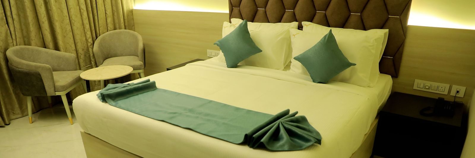 Spacious king-size bedroom at Town Square Suites featuring plush bedding and contemporary decor