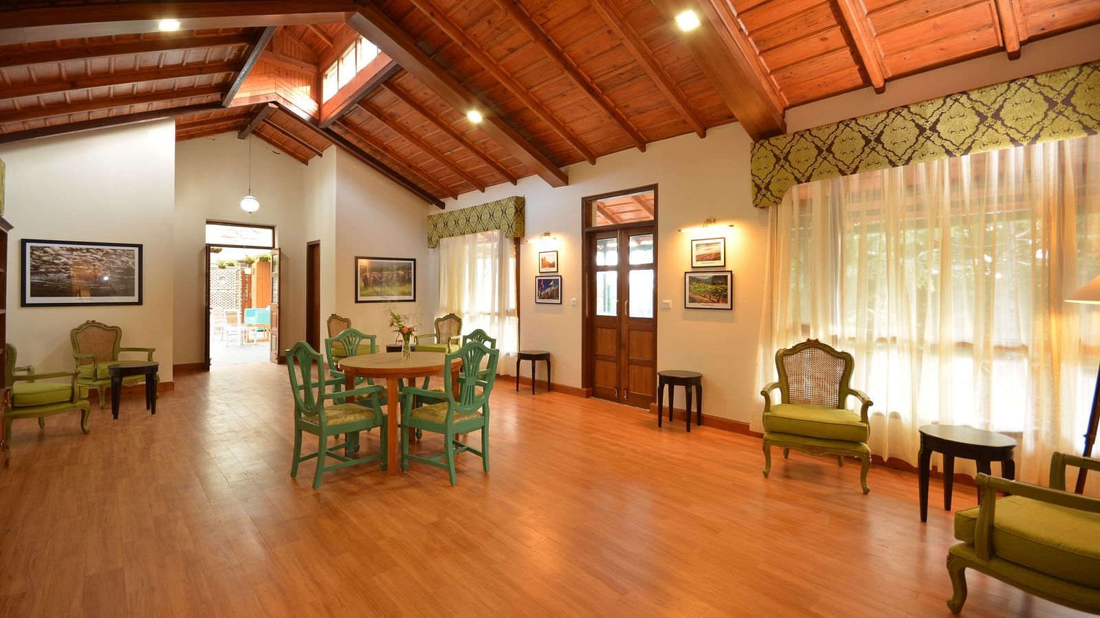 A brightly-lit hall in Almora with vintage-style furnishings and large windows - BluSalzz Escapade - Anant Rasa Resort