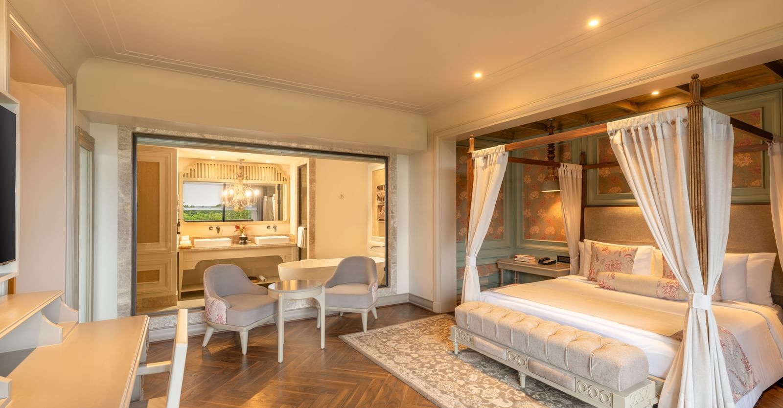 Side-view of the bedroom at the Evren Suite featuring a double bed along with a huge glass partition separating the bedroom with the bathroom at The Evren, Vagator.