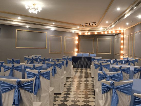 The beautifully appointed Party Hall with decorative lighting, elegant chair décor, and a cosy setting ideal for engagement ceremonies, cocktail evenings, and private celebrations | Clarks Amer, Jaipur