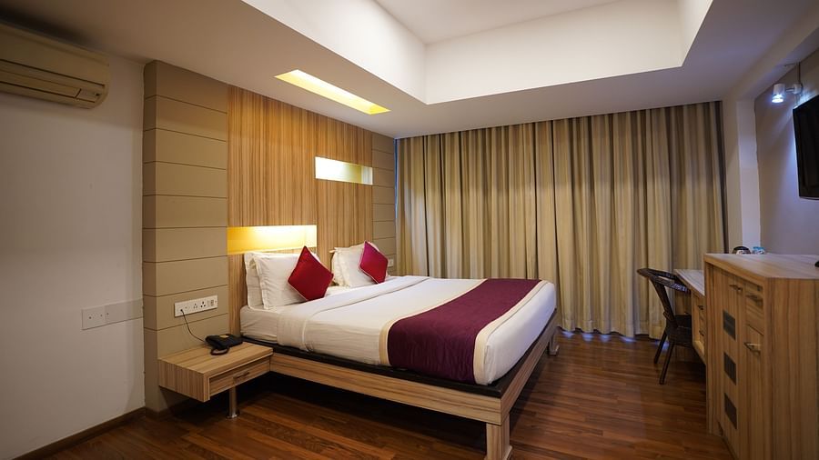 an image of suite with a bed and a television at  City Centre Residency, Bangalore