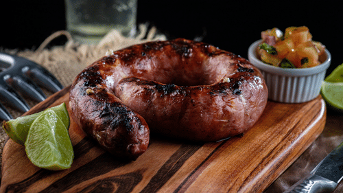 image featuring pork sausage kept on a wooden cutting board