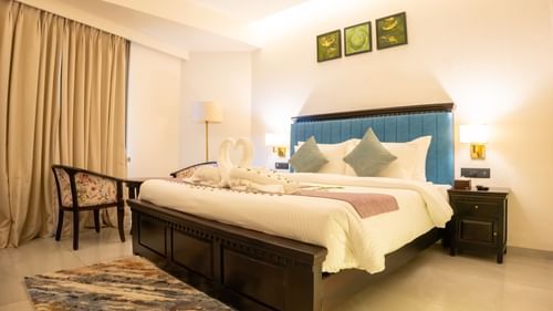 Image of a room with bed and and three frames above the bed at Pride Elite Daman.